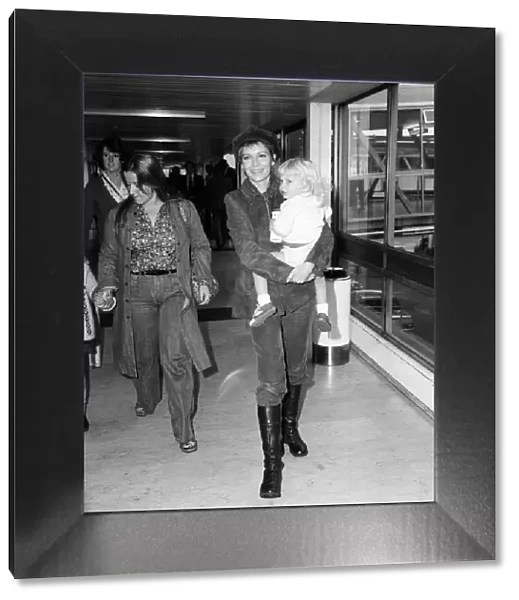 Mia Farrow at Heathrow Airport with her son Fletcher Previn. 27th September 1976