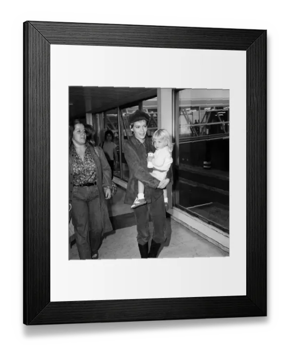 Framed Print : Mia Farrow at Heathrow Airport with her son Fletcher Previn. 27th September 1976 Framed Print : Mia Farrow at Heathrow Airport with her son Fletcher Previn. 27th September 1976