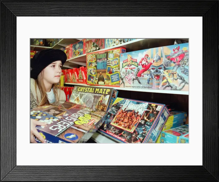 Framed Print : Nine year old Gemma Coakley from Easterside checks out the latest games from Telly