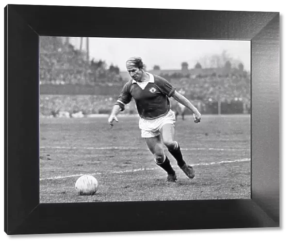 Bobby Charlton, playing for Manchester United in what would be his last season for