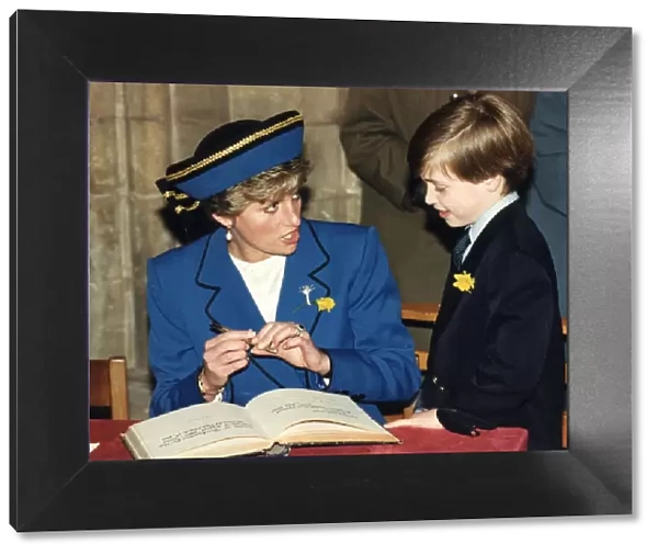 Princess Diana with her son Prince William signing their names in the visitors book of