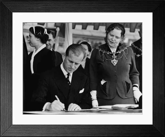Framed Print : The Duke of Edinburgh autographs the photographs which will be hung in Morecambe Town