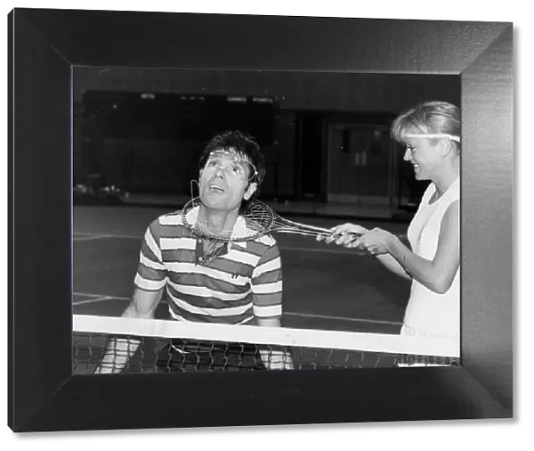 Sue Barker fooling around with Cliff Richard at doubles tennis match - December 1986