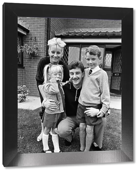 Liverpool footballer John Aldridge at home with his family. 13th September 1989