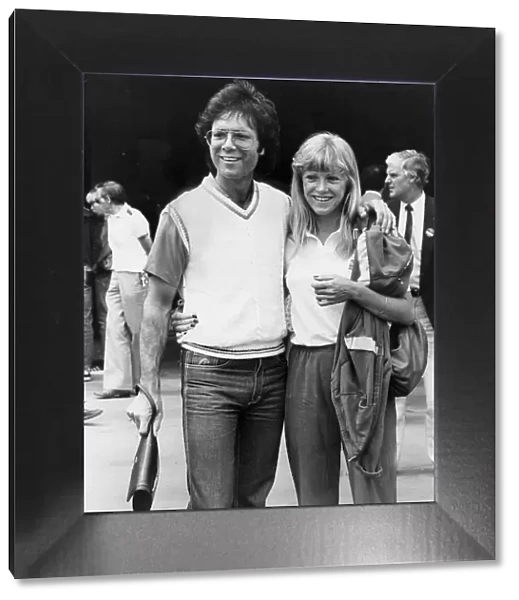 Sue Barker and Cliff Richard walking arm in arm during Wimbledon tournament - June 1983