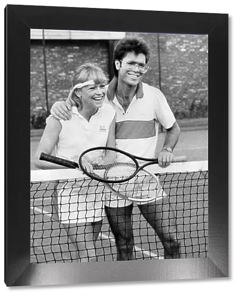 Sue Barker and Cliff Richard laughing during tennis match - October 1983