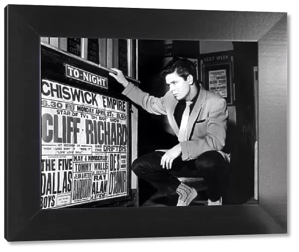 CLIFF RICHARD LOOKING AT CONCERT POSTER WITH HIS NAME AS TOP-BILLING - 1958