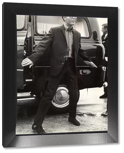 Cliff Richard in glasses getting out of a taxi 1964