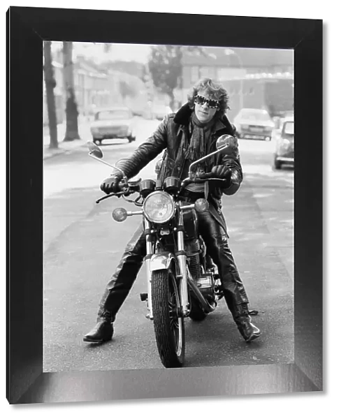 Stewart Copeland, drummer with the rock group, The Police, pictured on his motorbike