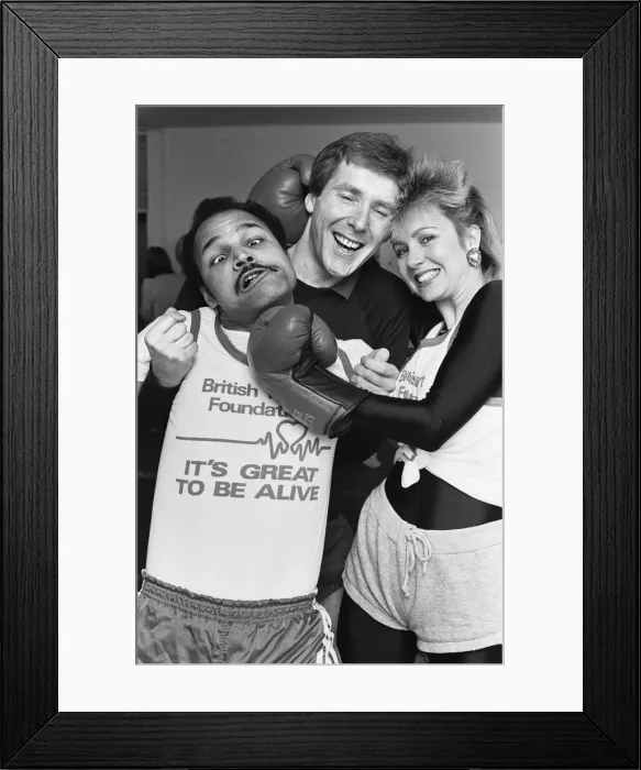 Framed Print : Saturday presenter Sarah Green, helped put John Conteh (left