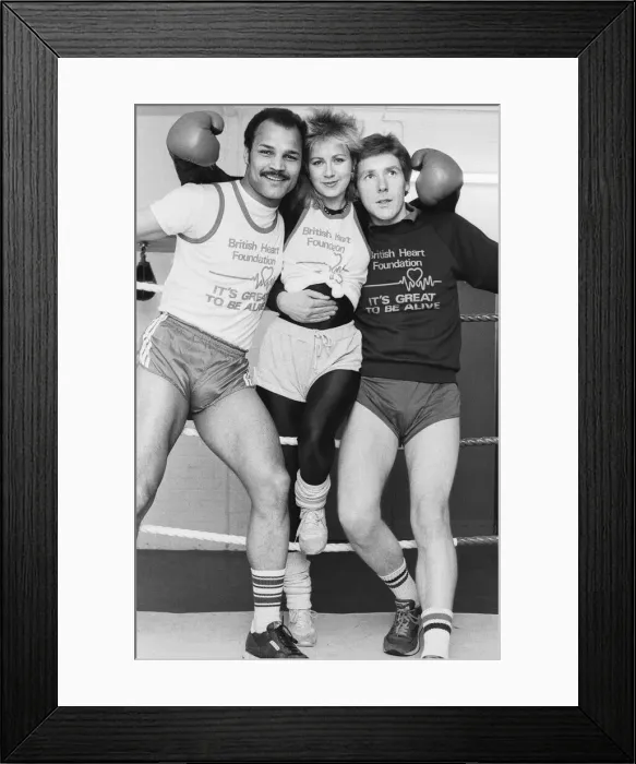 Framed Print : Saturday presenter Sarah Green, helped put John Conteh (left