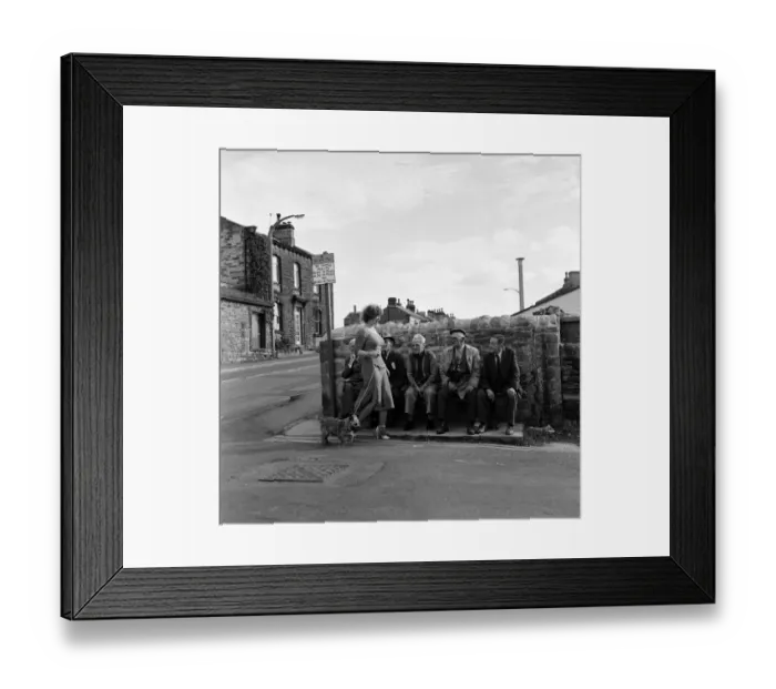 Framed Print : Old boys watch the girls go by from the bench at the junction of Keighly Road, Silsden