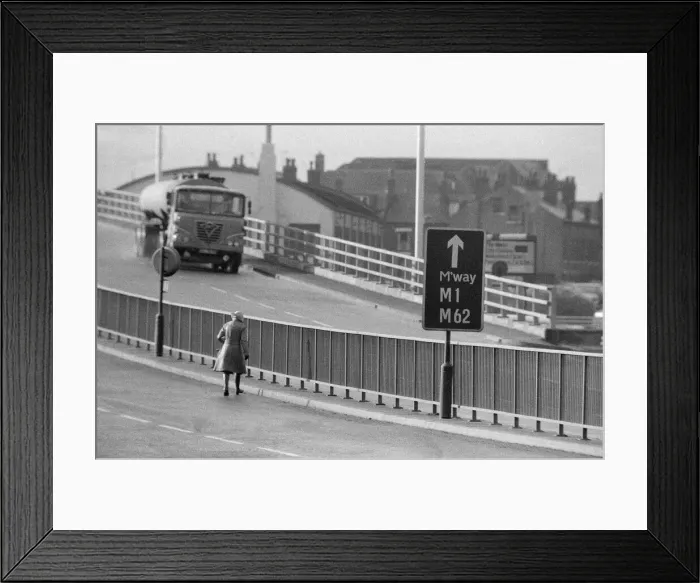 Framed Print : People crossing the motorway dangerously, in the north of England. 11th November 1974 Framed Print : People crossing the motorway dangerously, in the north of England. 11th November 1974