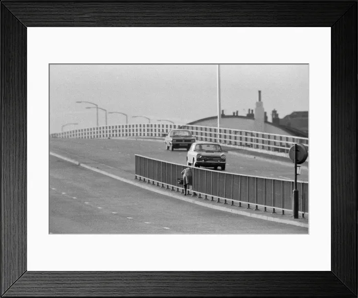Framed Print : People crossing the motorway dangerously, in the north of England. 11th November 1974 Framed Print : People crossing the motorway dangerously, in the north of England. 11th November 1974