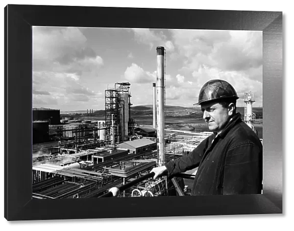 Llandarcy oil refinery. Blowerman Danny Evans looks out across the oil plant from a