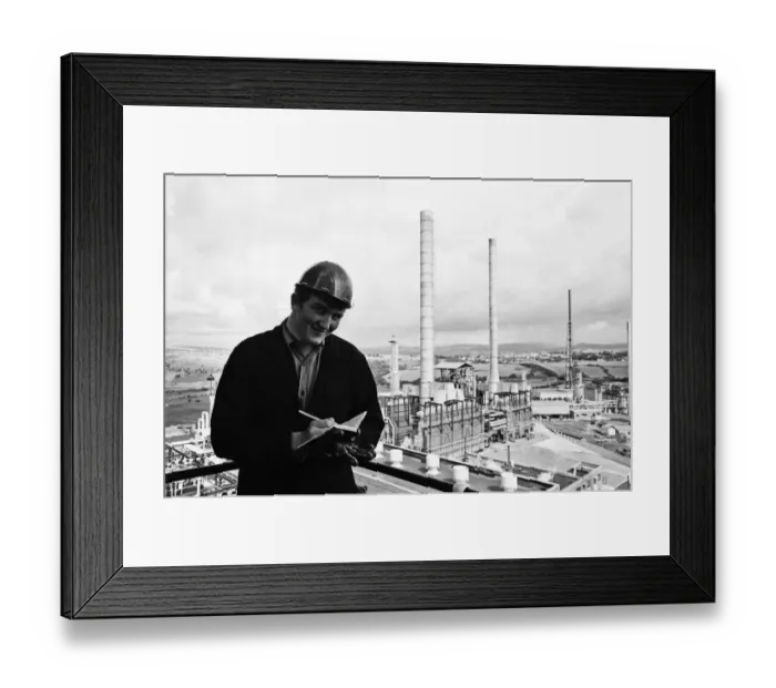 Framed Print : Llandarcy oil refinery. Philip Cole, 17, makes notes and looks out over the oil plant