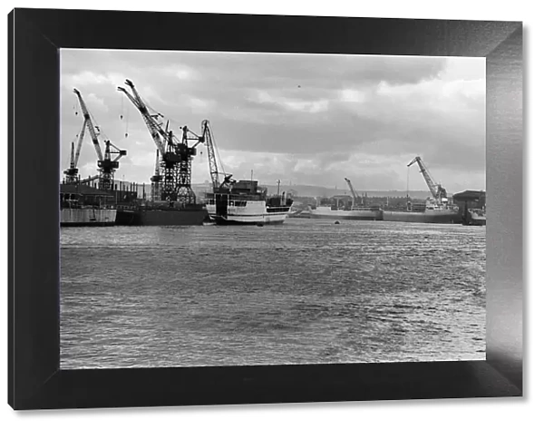 Looking up the Tyne to the ships being fitted out alongside the shipyards. 9th March 1967