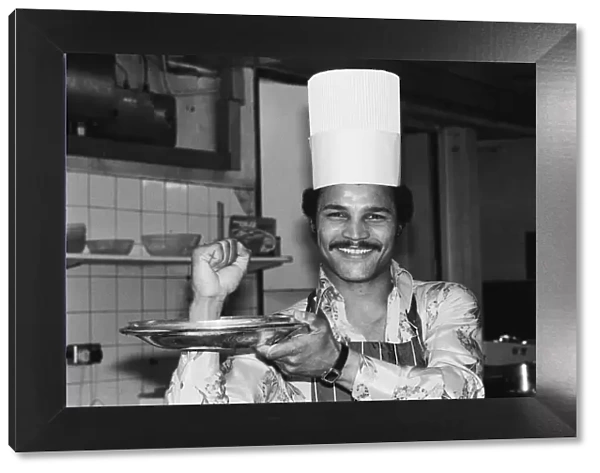 Boxer John Conteh with a chefs hat on. 28th September 1977