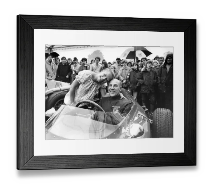 Framed Print : Stirling Moss sitting in Ferrari racing car with wife Suzy standing beside hie at Oulton