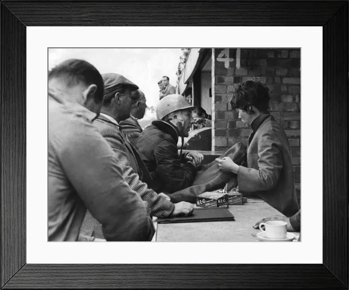 Framed Print : Stirling Moss talking with wife Katie in pits durng practise for International Trophy Framed Print : Stirling Moss talking with wife Katie in pits durng practise for International Trophy