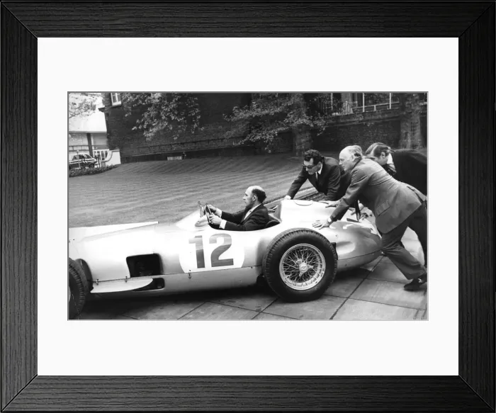 Framed Print : Stirling Moss sitting in his Mercedes racing car being pushed by Lord Montagu - May 1973