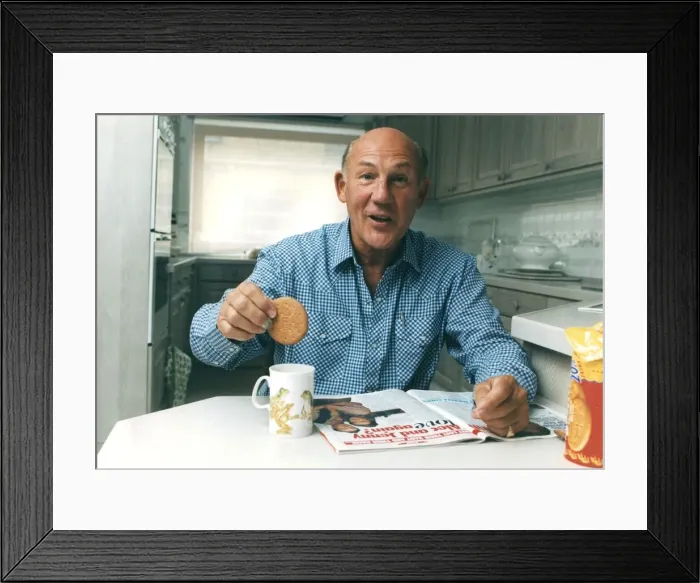 Framed Print : Stirling Moss dunkning biscuit in cup of tea reading magazine - June 1993 Framed Print : Stirling Moss dunkning biscuit in cup of tea reading magazine - June 1993