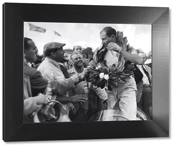 Stirling Moss wearing victory wreath afetr OUlton Park Gold Cup motor race - September