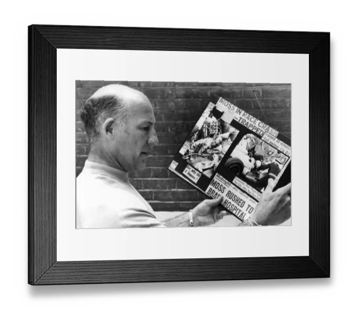 Framed Print : Stirling Moss reading clippings of his crash during race - August 1982 Framed Print : Stirling Moss reading clippings of his crash during race - August 1982