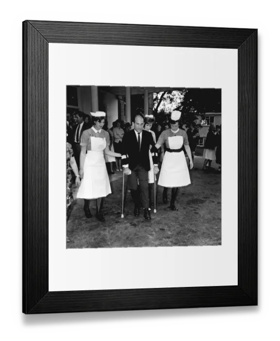Framed Print : Stirling Moss motor racing driver leaving hospital 1962 on crutches with help of Framed Print : Stirling Moss motor racing driver leaving hospital 1962 on crutches with help of