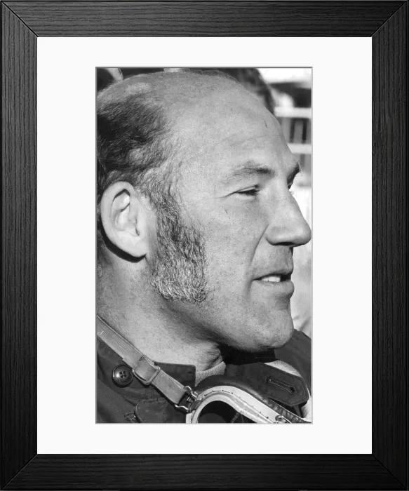Framed Print : Stirling Moss in profile serious during interview at track - December 1971 Framed Print : Stirling Moss in profile serious during interview at track - December 1971