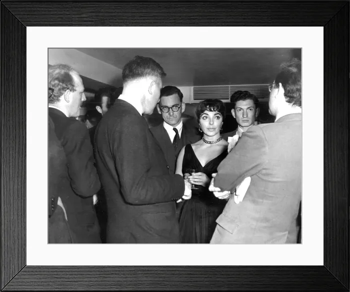 Framed Print : Joan Collins among crowd of reporters at press event at the Savoy Hotel - October 1955