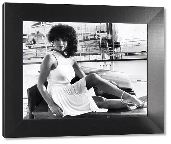 Joan Collins posing on quayside at Cannes film festival - May 1979