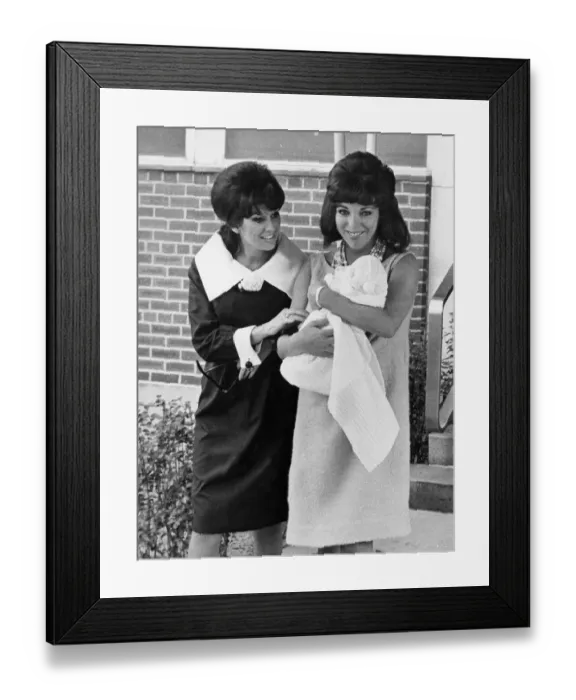 Framed Print : Joan Collins carrying baby daughter Tara with her sister Jackie Collins - 18th October