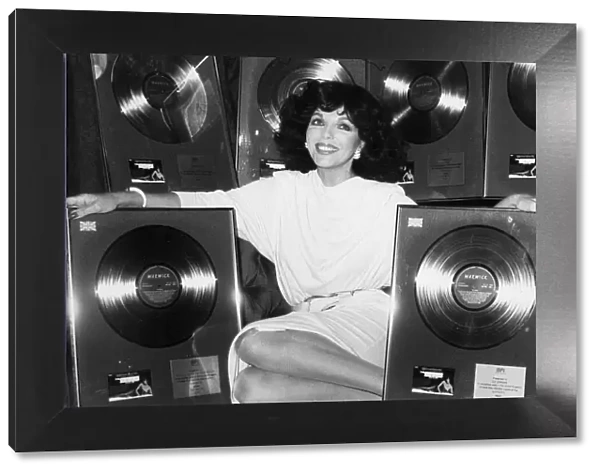 Joan Collins with gold discs presented for The Bitch soundtrack - March 1980