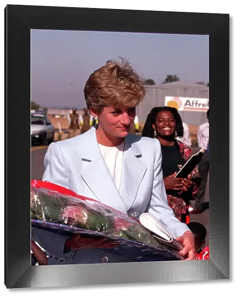 PRINCESS OF WALES HOLDING FLOWERS DURING A VISIT TO RED CROSS CHARITY PROJECT IN ZIMBABWE