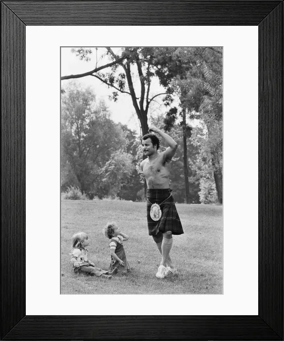 Framed Print : John Conteh gets the Scottish flavour on Parliament Hill Fields today watched by curious Framed Print : John Conteh gets the Scottish flavour on Parliament Hill Fields today watched by curious