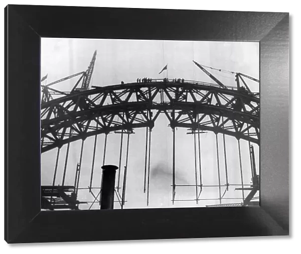 Construction of the new Tyne Bridge. The Union Jack on the top after the joining up of