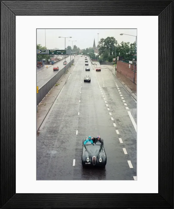 Framed Print : Sterling Moss takes takes Evening Telegraph reporter Alan Poole for a spin in the same Framed Print : Sterling Moss takes takes Evening Telegraph reporter Alan Poole for a spin in the same