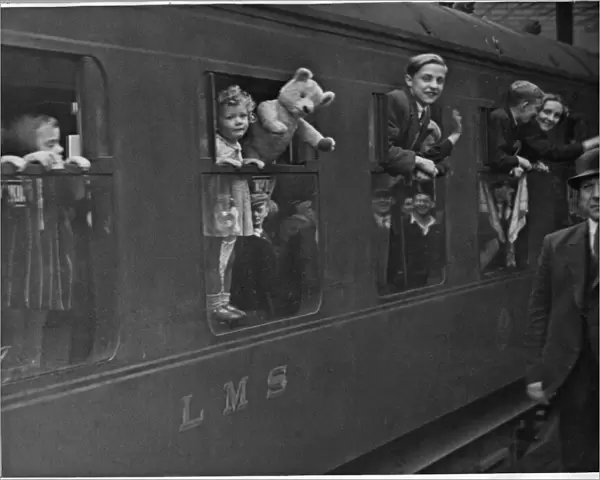 Returning evacuee children wave goodbye to Derby as their train moves out