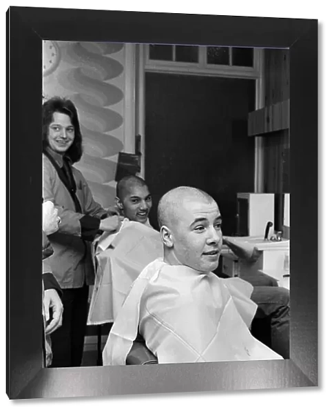 Two men getting 'Kojak'hair cuts. 1975