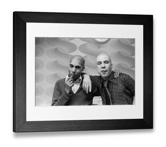Framed Print : Two men with Kojak'hair cuts. 1975