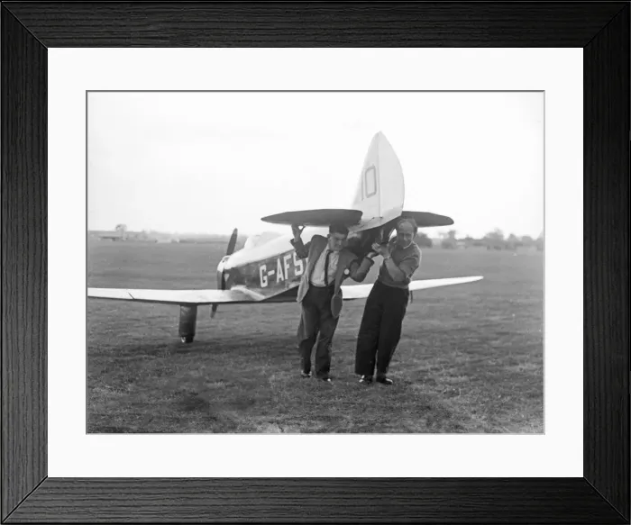 Framed Print : Two men manually transporting a Chilton DW1A across the field at Bagington Circa 1955 Framed Print : Two men manually transporting a Chilton DW1A across the field at Bagington Circa 1955