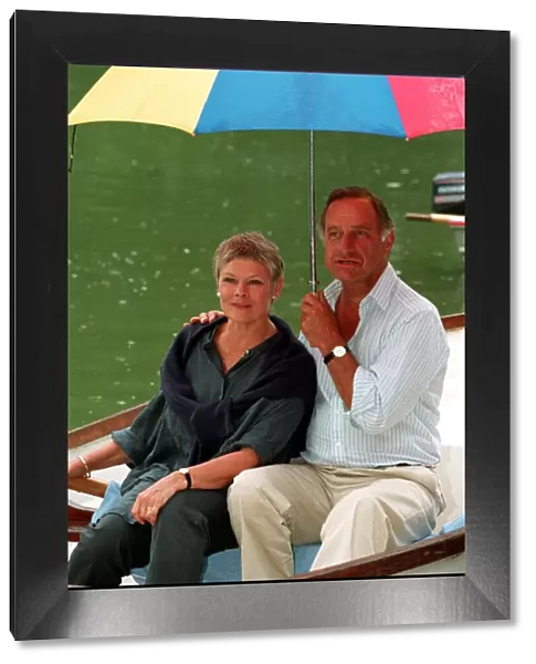 DAME JUDi DENCH & GEOFFREY PALMER (HOLDING UMBRELLA) SEATED IN ROWING BOAT DURING FILMING