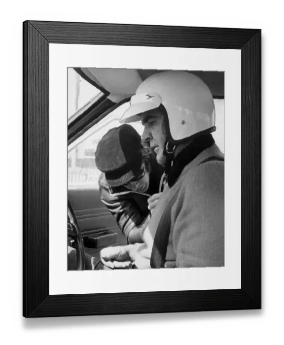 Framed Print : Sean Connery being strapped into motor car for lesson in grand prix driving