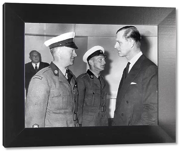Prince Phillip president of the a with two patrol men who received a medals for