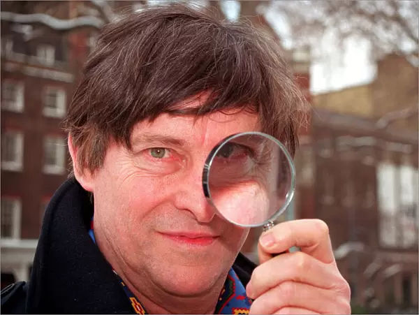 JEREMY BRETT, ACTOR, IN PHOTOCALL FOR SHERLOCK HOLMES, HOLDING MAGNIFYING GLASS