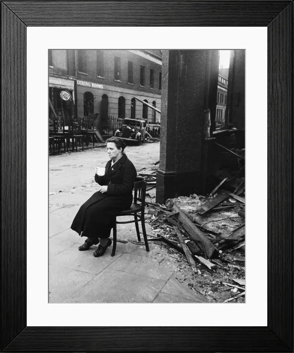 Framed Print : Bomb damaged near Waterloo Station. A lady sits in solitary state drinking tea Framed Print : Bomb damaged near Waterloo Station. A lady sits in solitary state drinking tea