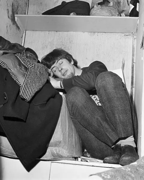 John Mayall of the Bluesbreakers, takes a nap in the band room between performances