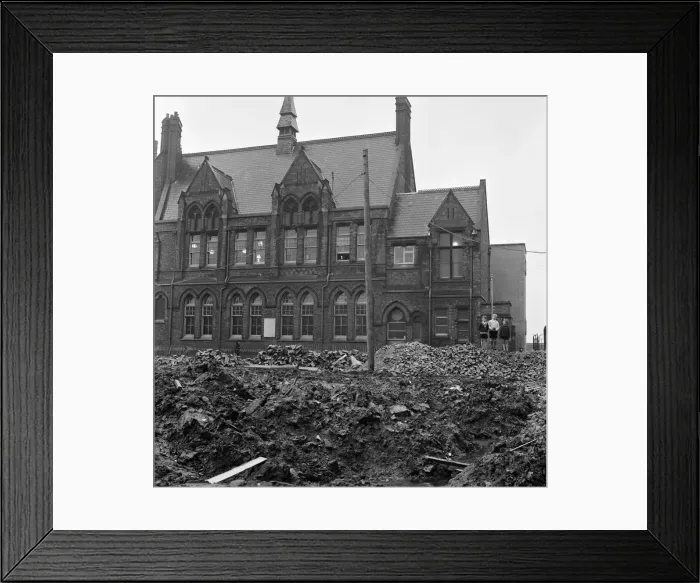 Framed Print : Pupils of Ross Place School, Ardwick, Manchester, jump across a sea of mud to enter Framed Print : Pupils of Ross Place School, Ardwick, Manchester, jump across a sea of mud to enter