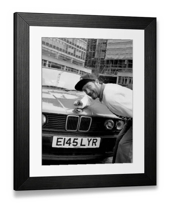 Framed Print : Kenny Everett sitting with his new BMW car 21  /  07  /  1989